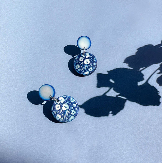 Pair of earrings with floral engraved design made with tagua nut beads.