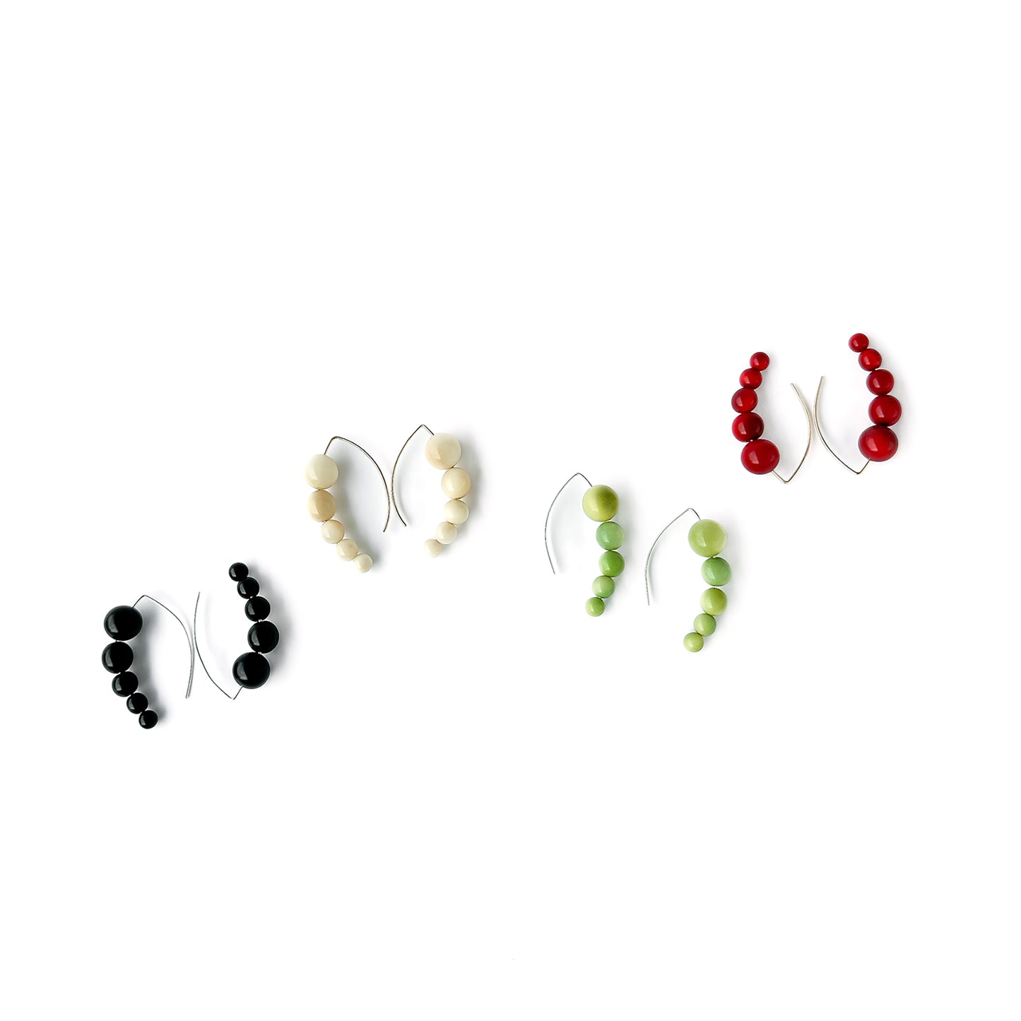 Harmony 5 earrings made of tagua nut spheres threaded into a handmade sterling silver earring hoop