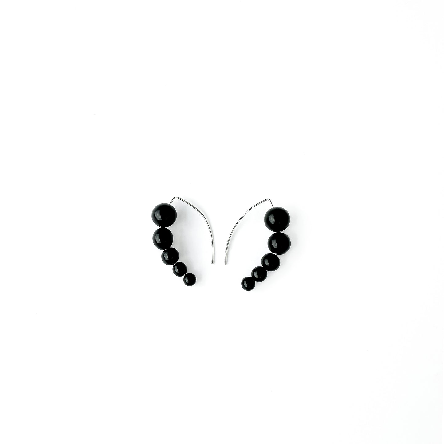 Harmony 5 earrings made of tagua nut spheres threaded into a handmade sterling silver earring hoop