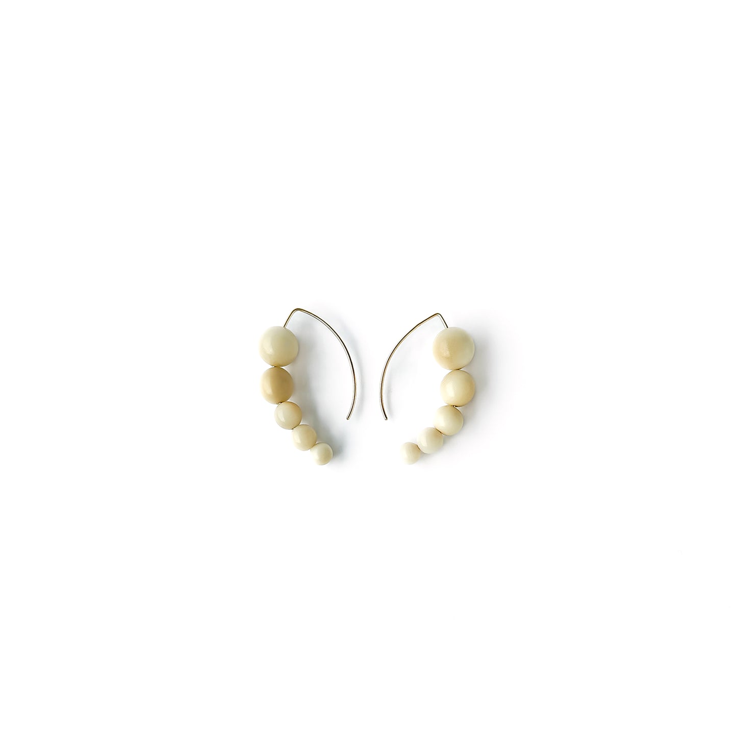 Harmony 5 earrings made of tagua nut spheres threaded into a handmade sterling silver earring hoop