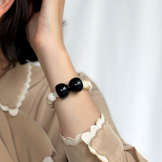 Bracelet handmade with tagua nut spheres worn by model