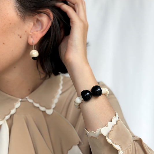 Model wearing Tagua nut earrings with handmade sterling silver hooks
