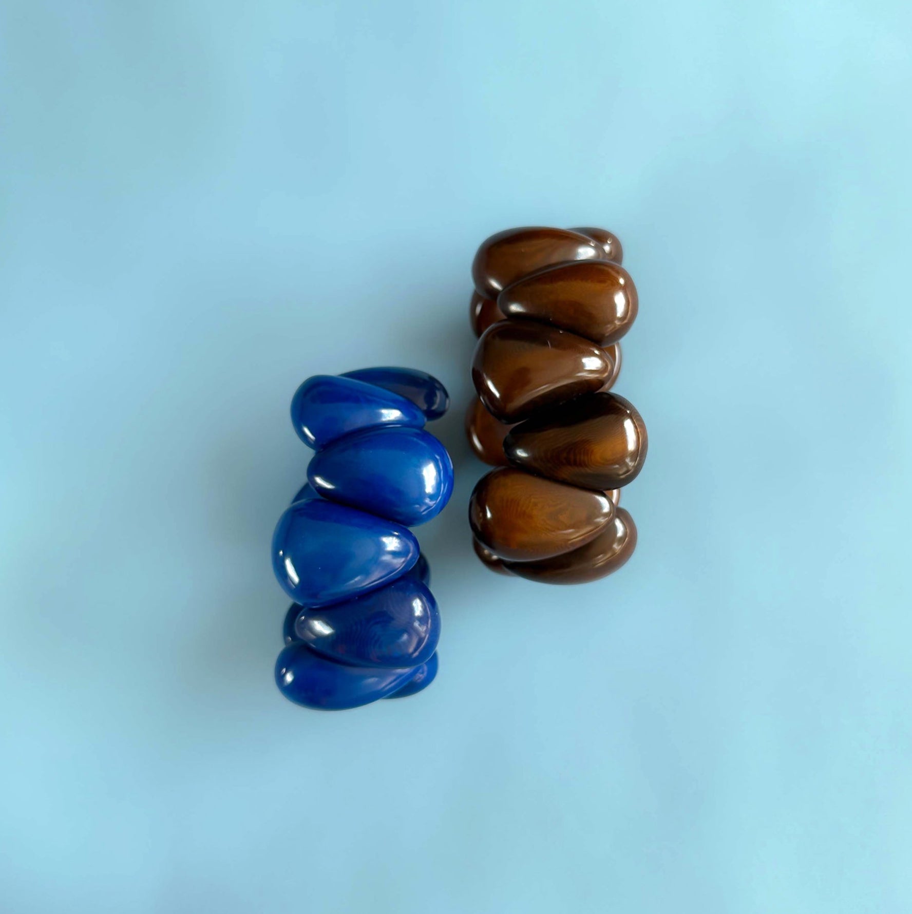 Blue and brown Modern organic design bracelet, made of sustainable tagua nut / vegetable ivory on a light blue background