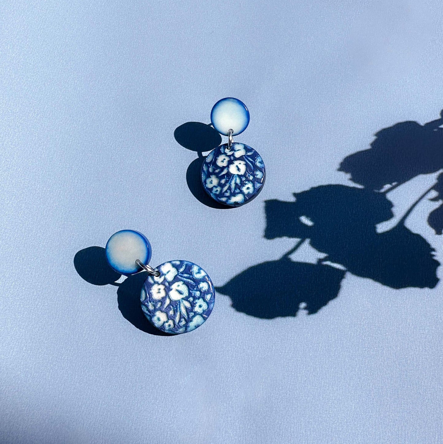 Pair of earrings with floral engraved design made with tagua nut beads.