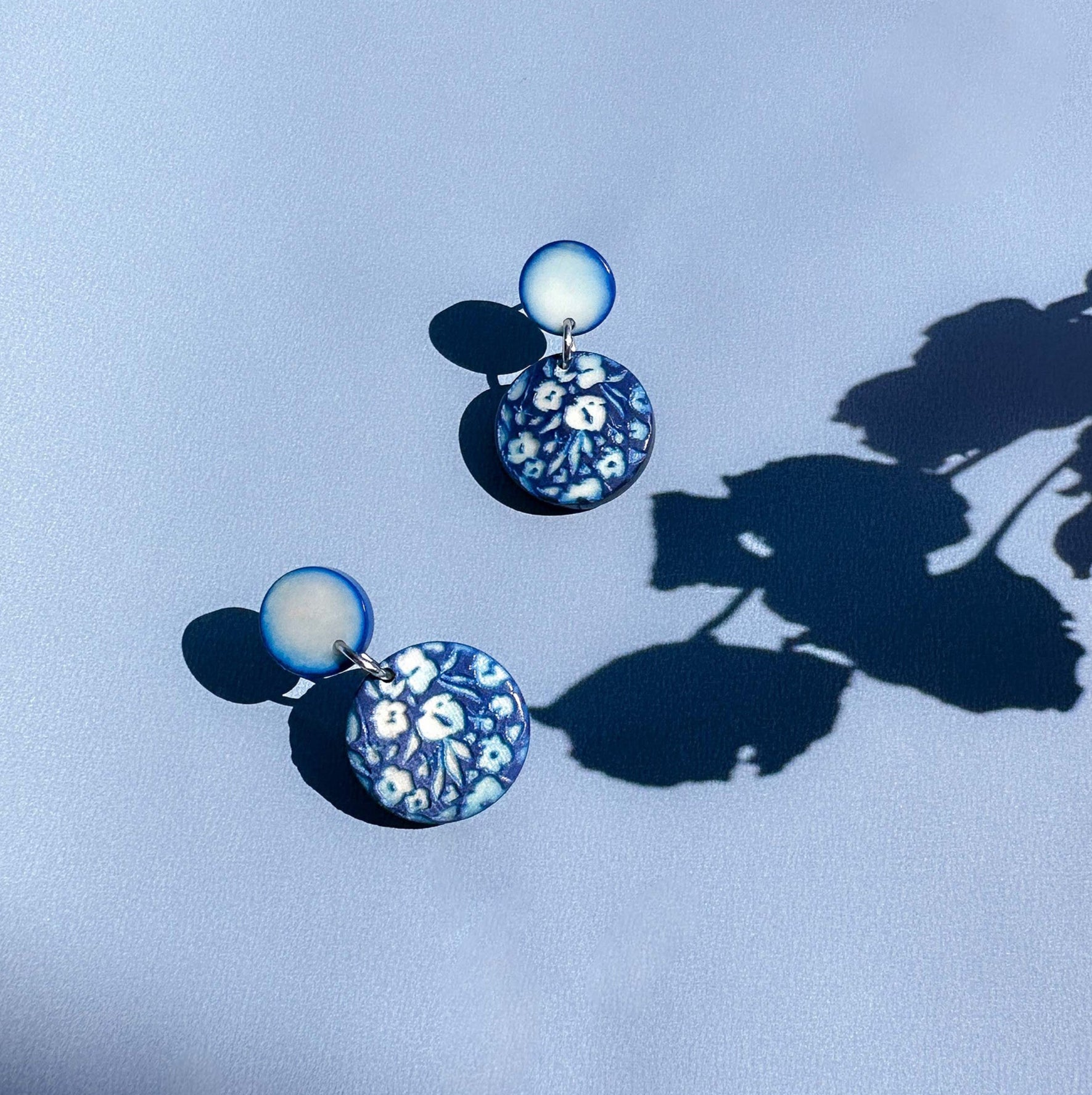 Pair of earrings with floral engraved design made with tagua nut beads.