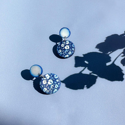 Pair of earrings with floral engraved design made with tagua nut beads.