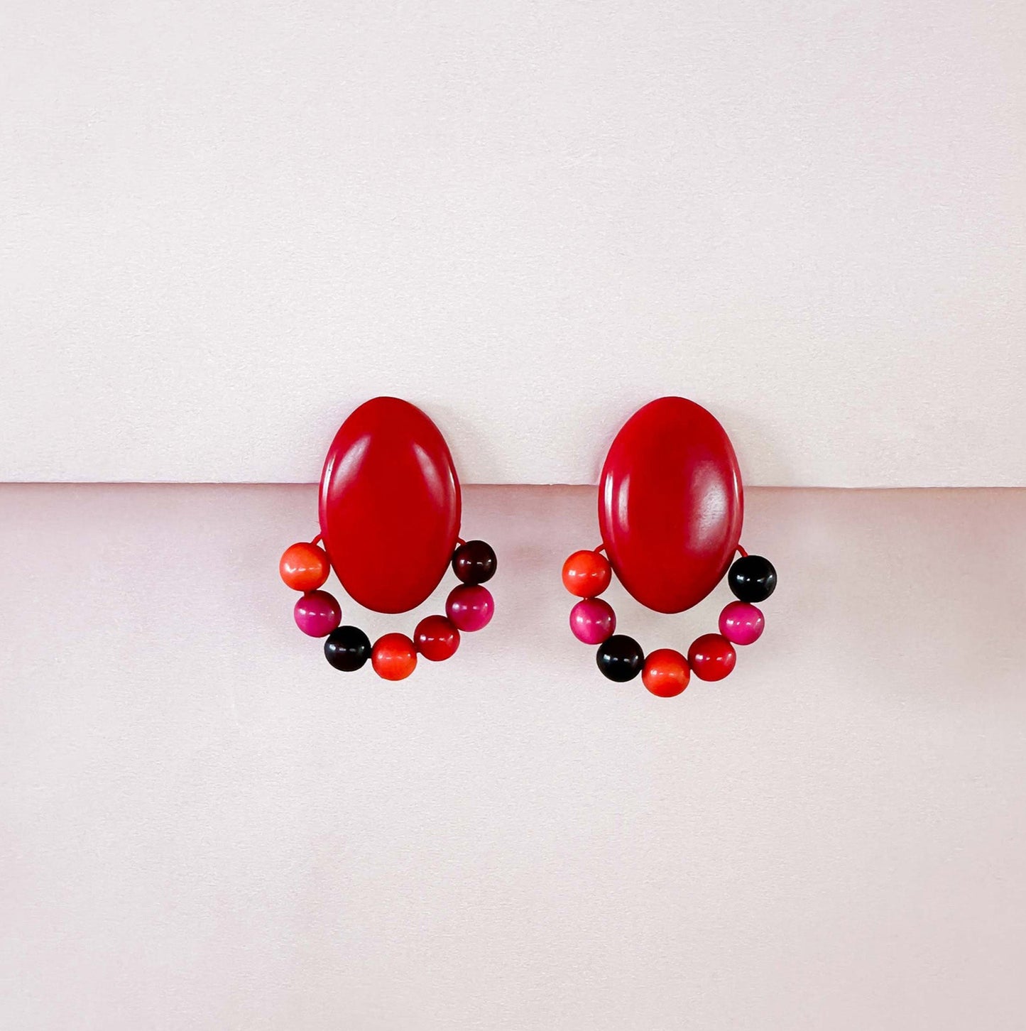 Colourful earrings, handmade with tagua nut beads and natural dyes.