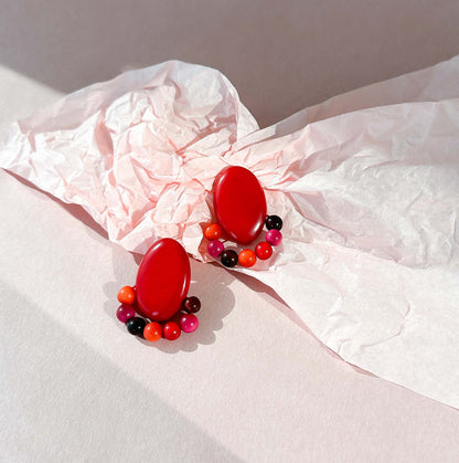 Red earrings handmade with tagua nut beads and natural dyes.