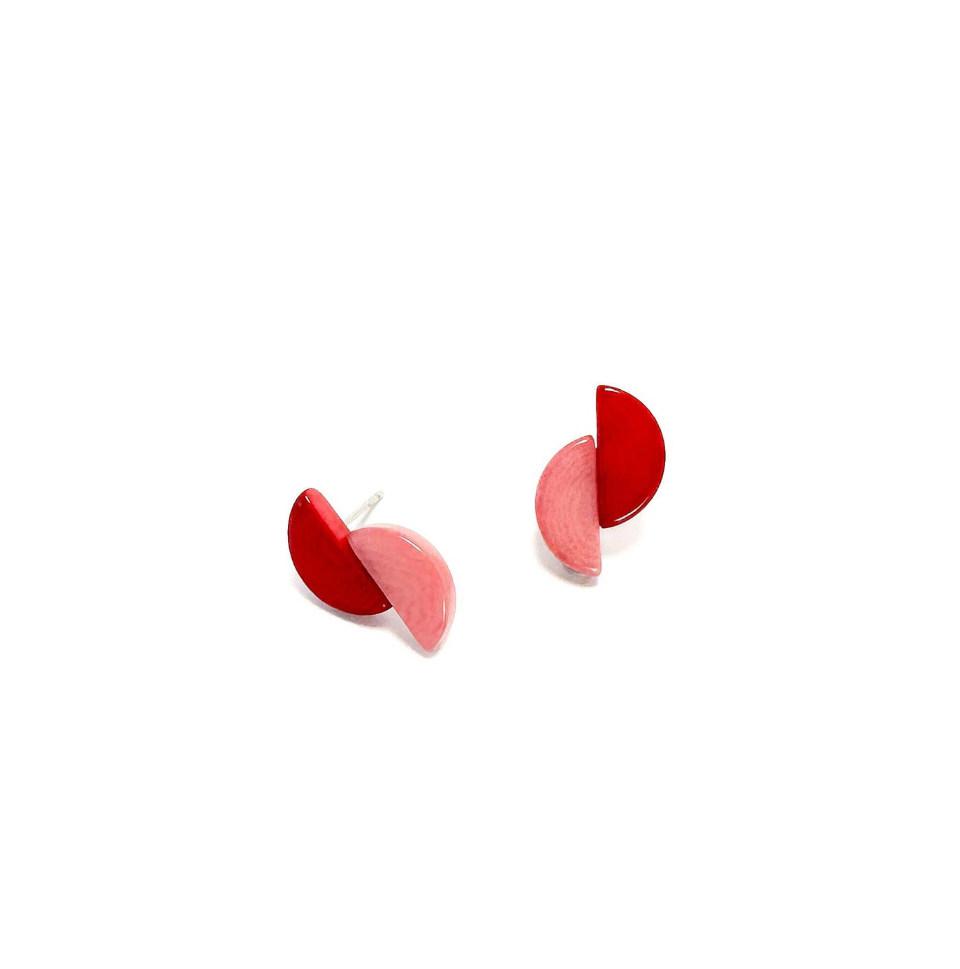 Red and pink tagua nut earrings on a white background