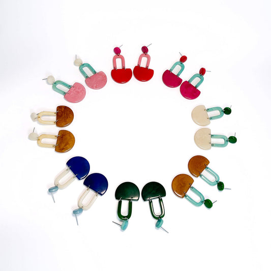 Colourful dangling earrings made with tagua nut beads, displayed in a round shape