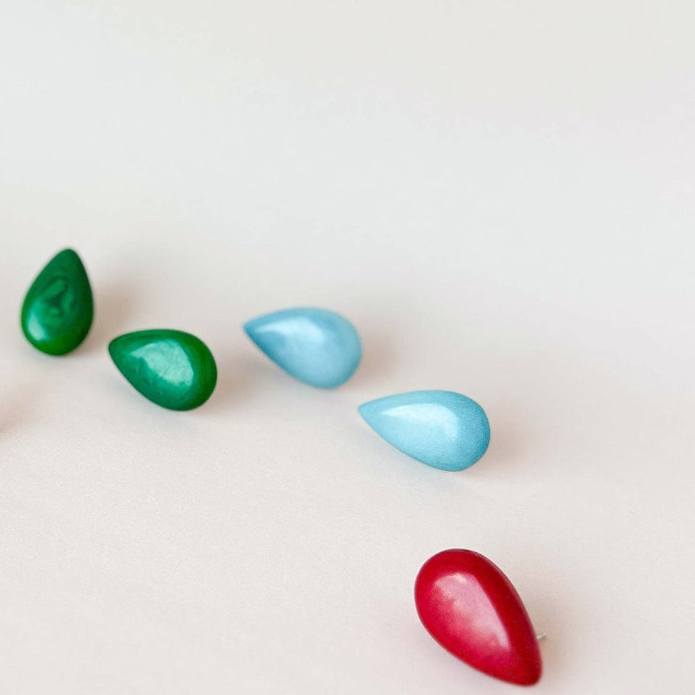 A set of small teardrop-shaped tagua nut stud earrings 