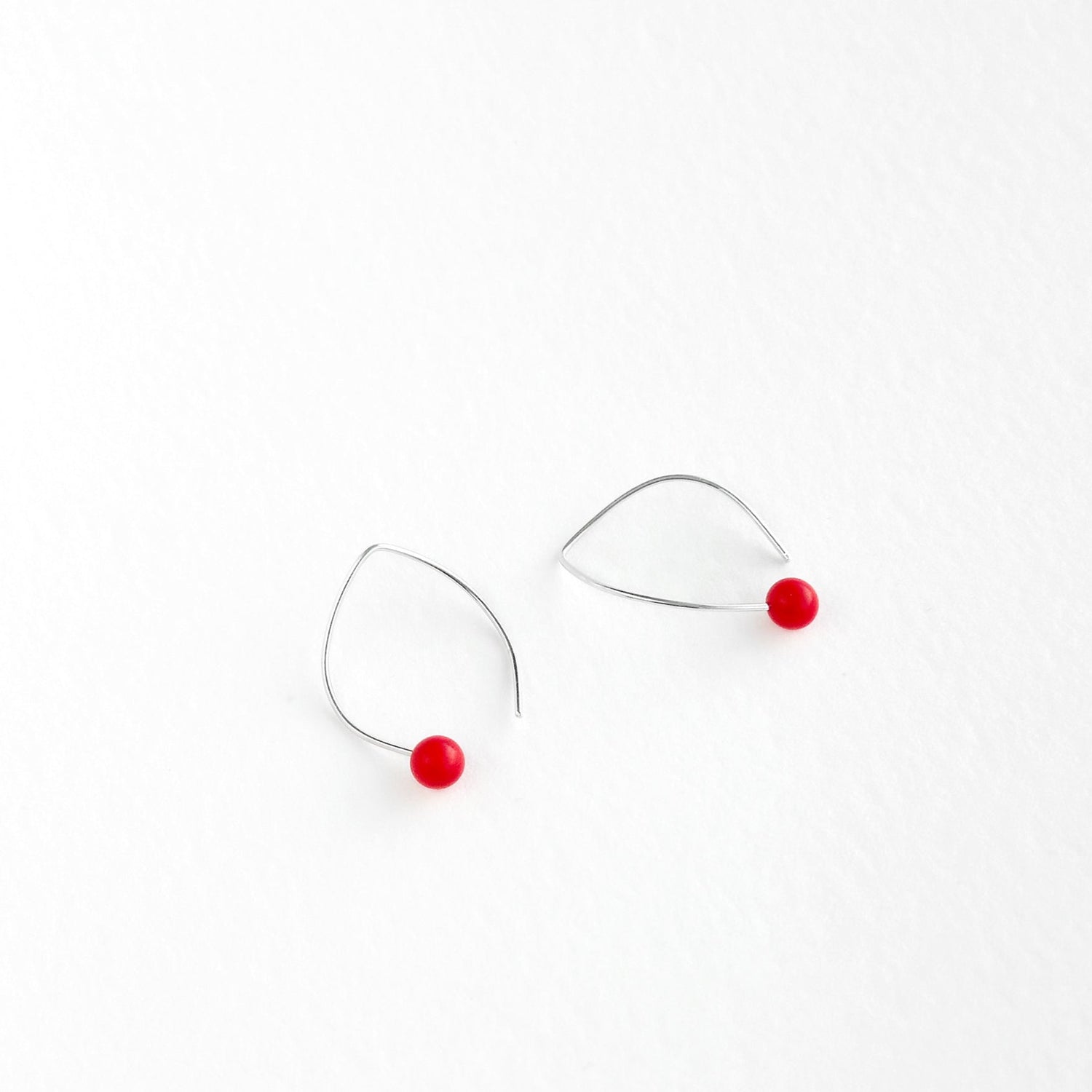 Handmade sterling silver hook earrings with a red tagua nut bead