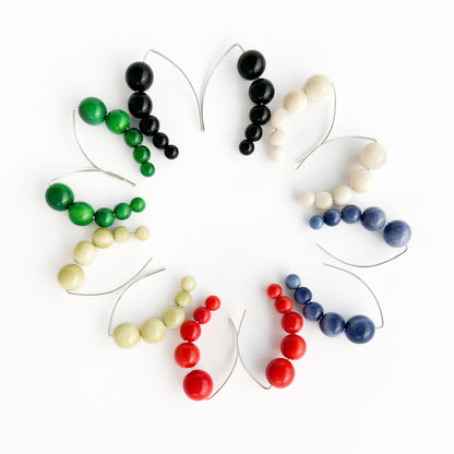 Harmony 5 earrings made of tagua nut spheres threaded into a handmade sterling silver earring hoop
