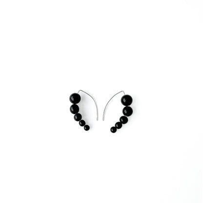 Harmony 5 earrings made of tagua nut spheres threaded into a handmade sterling silver earring hoop
