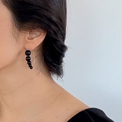 Harmony 5 earrings made of tagua nut spheres threaded into a handmade sterling silver earring hoop