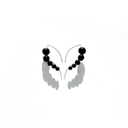 Harmony 5 earrings made of tagua nut spheres threaded into a handmade sterling silver earring hoop