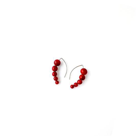 Harmony 5 earrings made of tagua nut spheres threaded into a handmade sterling silver earring hoop