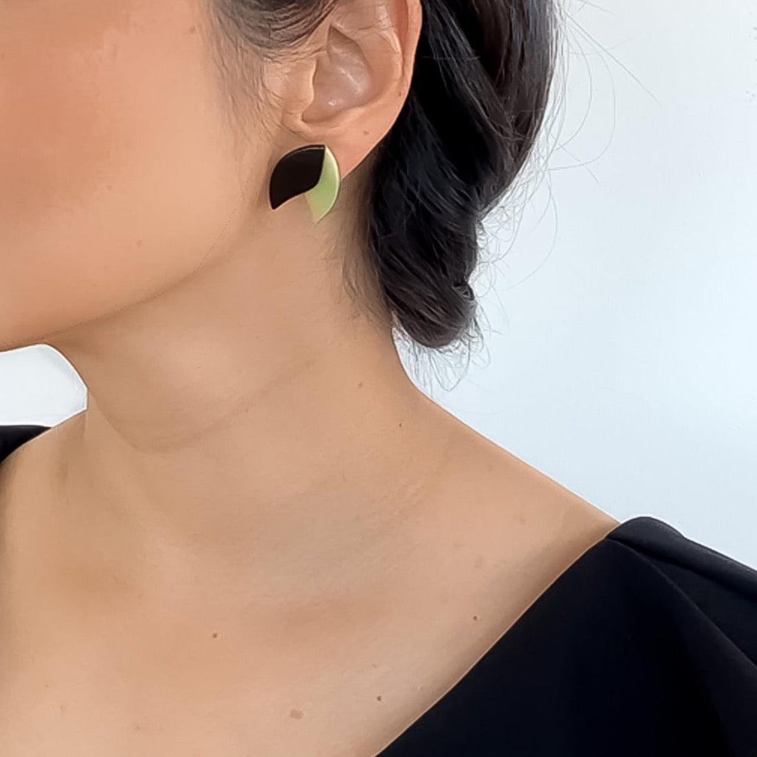 Model wearing Delicate earrings shape as a lotus flower in contrasting colours