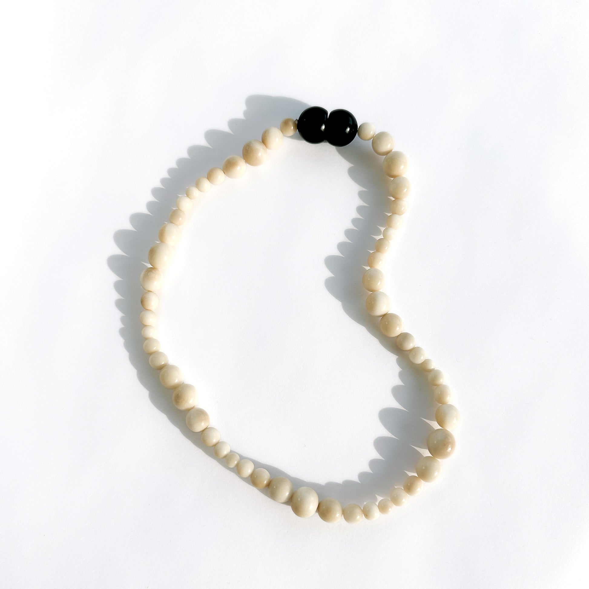 Necklace that boasts a delicate array of tagua nut beads and a secure magnetic closure that emits a charming click when locked