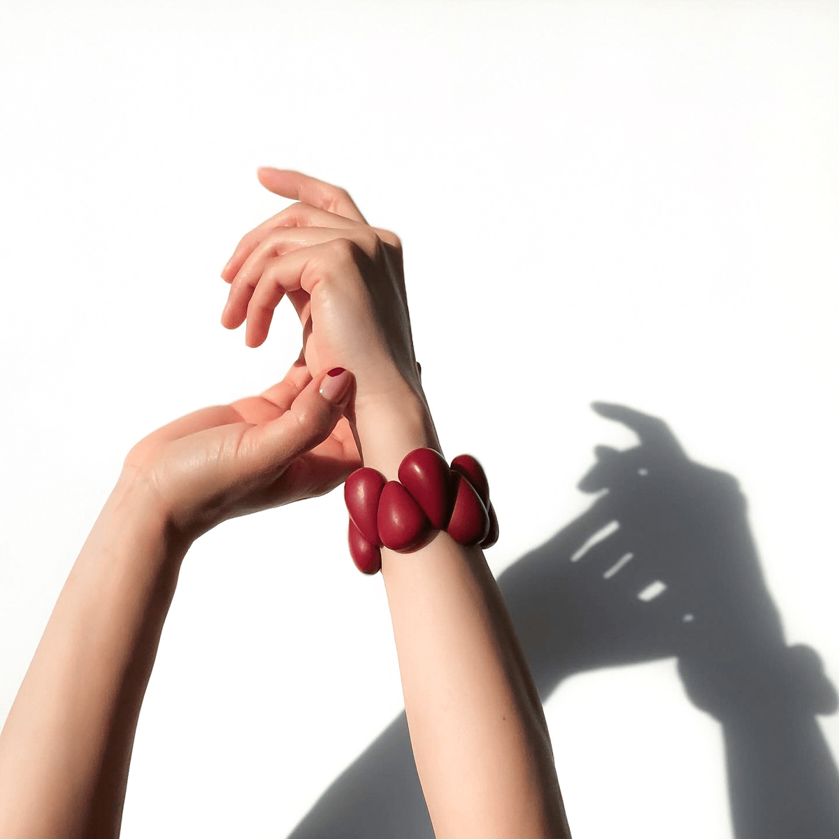 Handmade tagua nut bracelet with hands raise to the sun